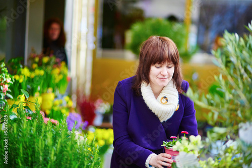 Beautiful young woman selecting fresh flowers