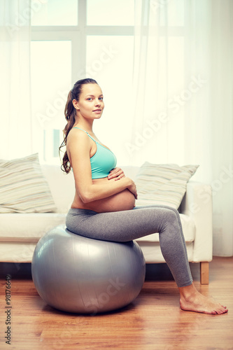 Free Download happy pregnant woman exercising on fitball at home - GFXLoad