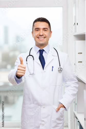 smiling doctor in white coat at medical office