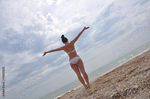 Beautiful young girl loking on the sea