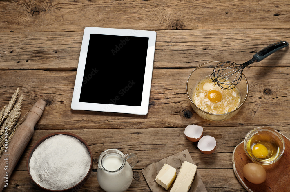 Baking ingredients with white tablet computer Baking ingredients with white tablet computer