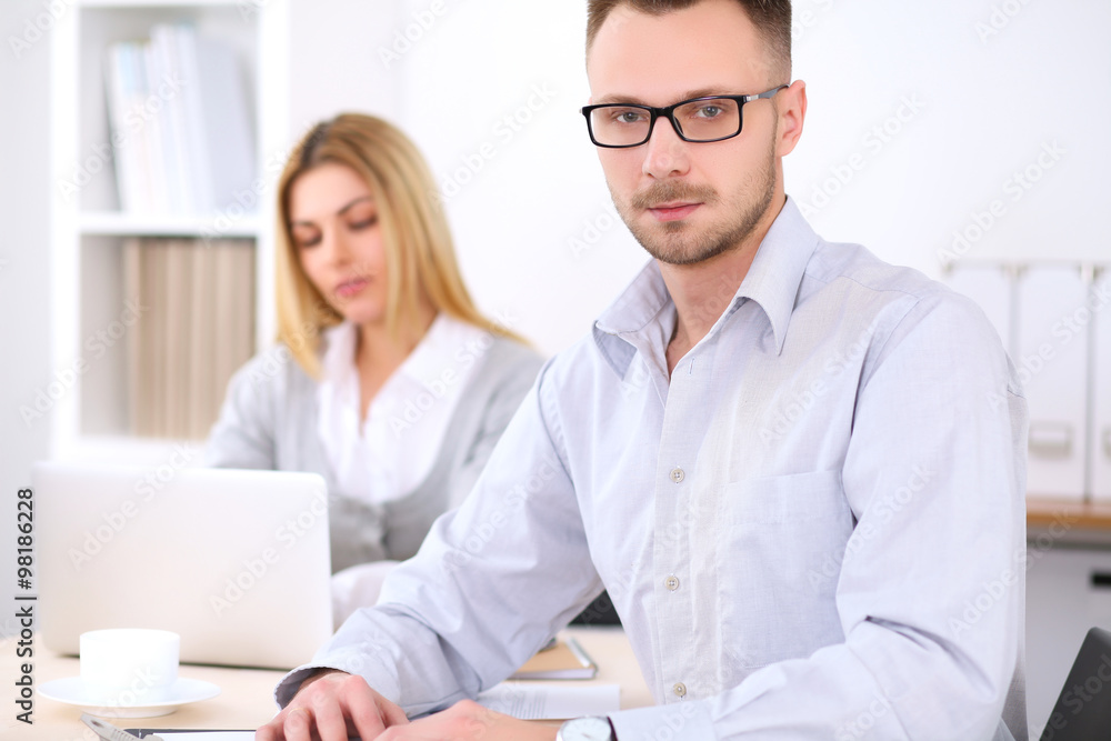 Successful businesspeople working at meeting in office. Businessman looking at camera. Start up business concept. Successful businesspeople working at meeting in office. Businessman looking at camera. Start up business concept.