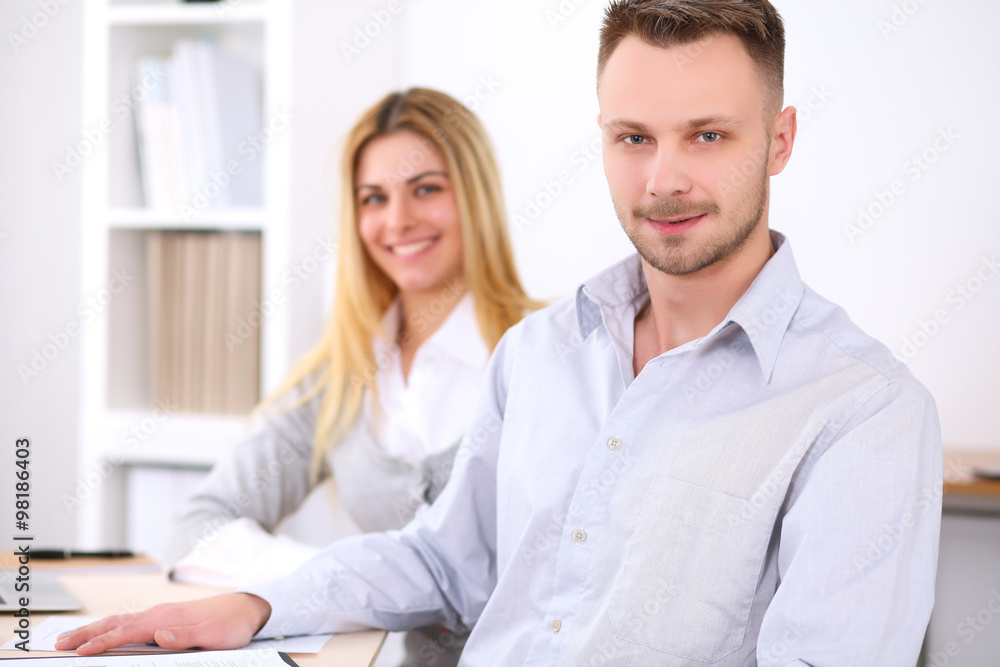Successful businesspeople working at meeting in office. Businessman looking at camera. Start up business concept. Successful businesspeople working at meeting in office. Businessman looking at camera. Start up business concept.