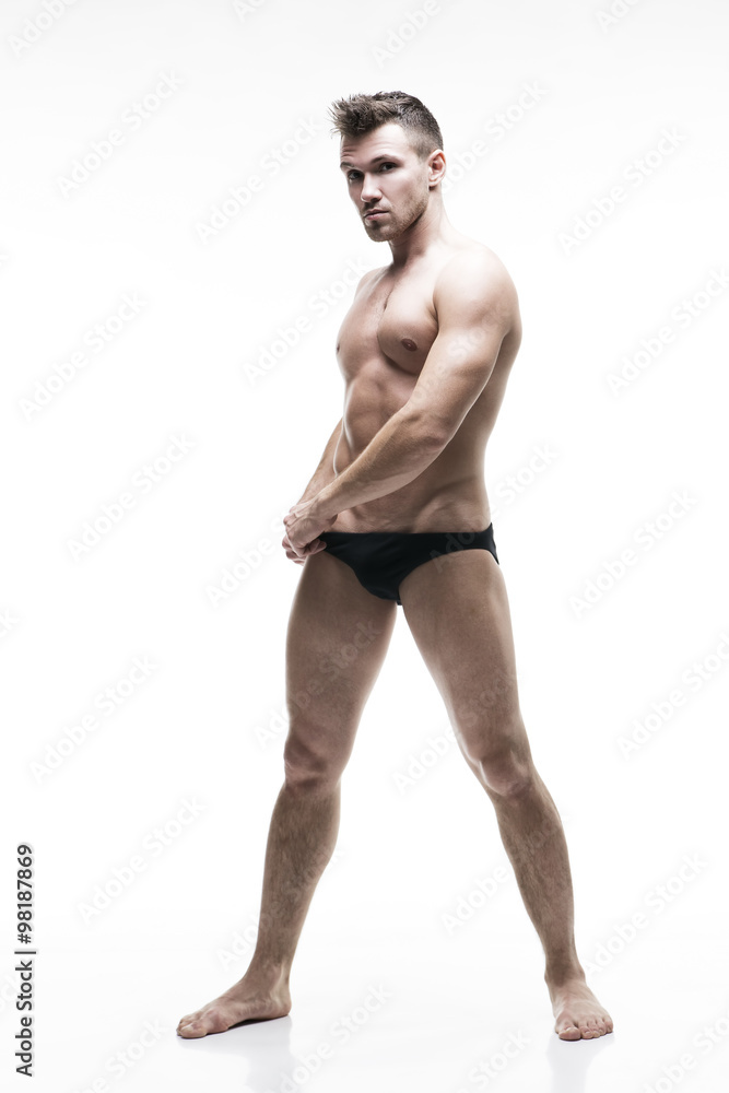 Handsome muscular bodybuilder posing on white background. Isolated studio shot