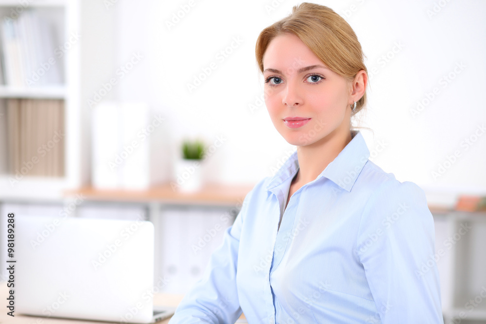 Young blonde business woman with laptop in the office. Business concept. Young blonde business woman with laptop in the office. Business concept.