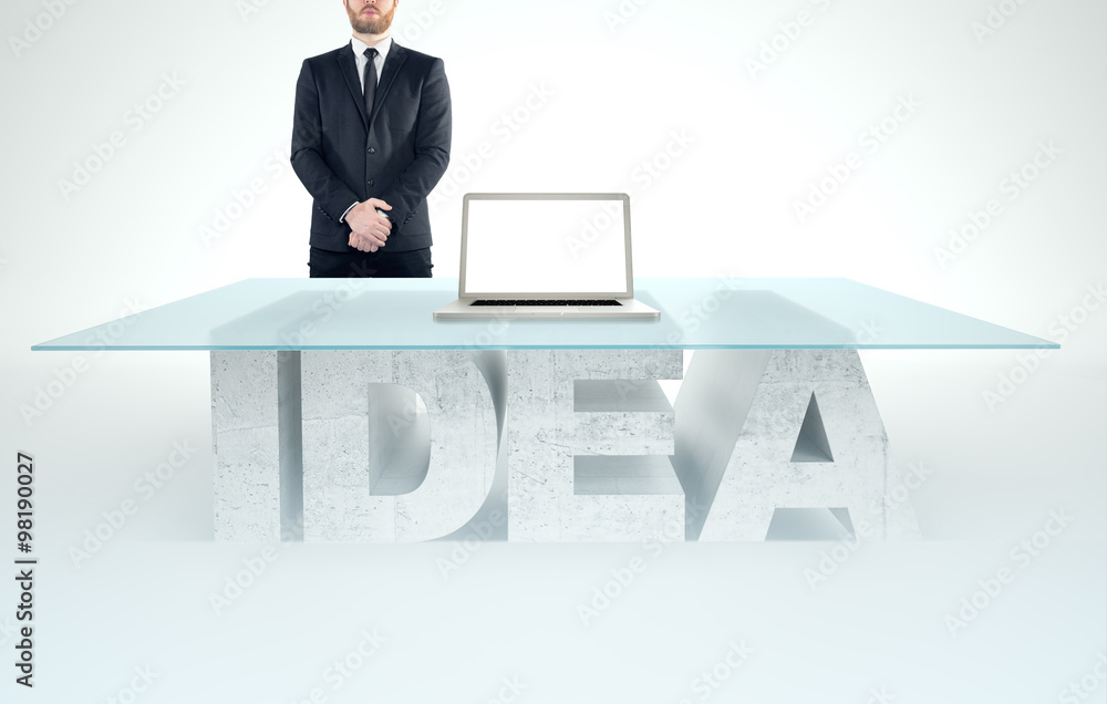 Confident business man leaning on empty glass table with a base made of concrete IDEA. Business concept Confident business man leaning on empty glass table with a base made of concrete IDEA. Business concept