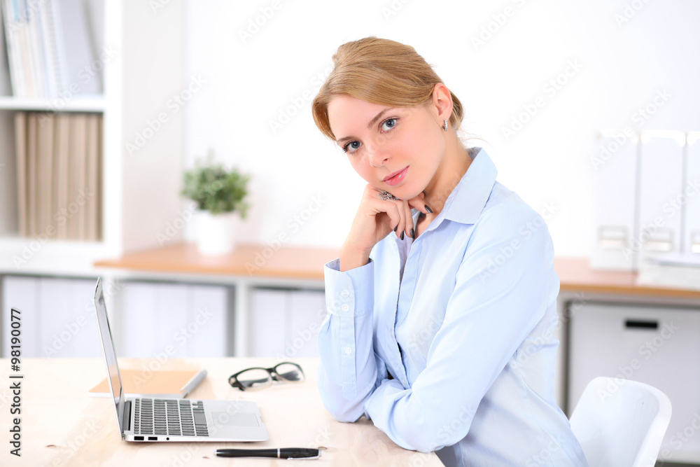 Young blonde business woman with laptop in the office. Business concept. Young blonde business woman with laptop in the office. Business concept.