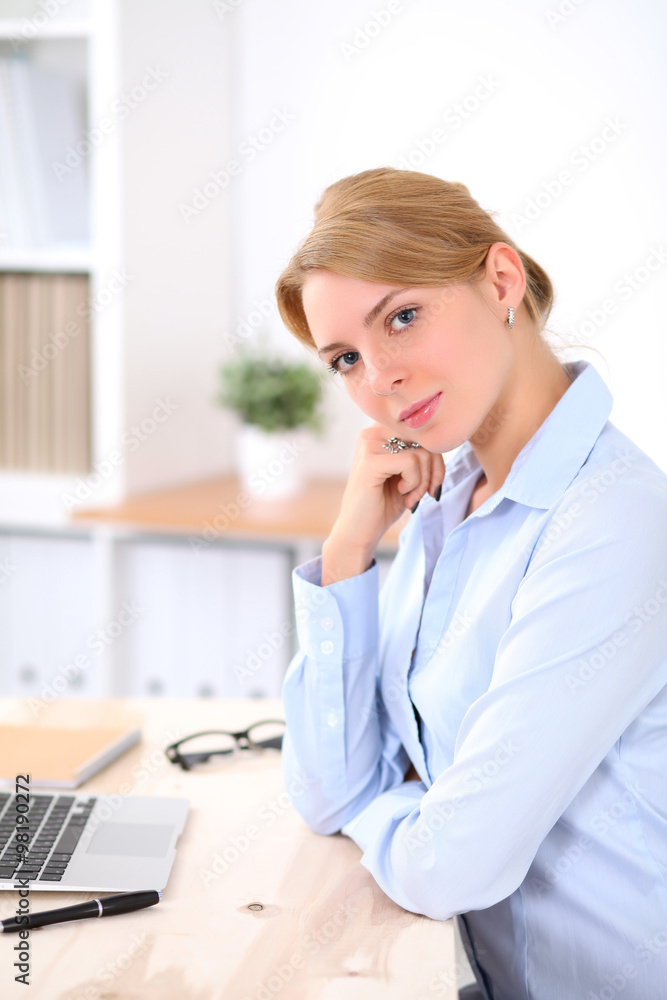 Young blonde business woman with laptop in the office. Business concept. Young blonde business woman with laptop in the office. Business concept.