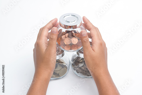 Woman hands with money in glass jar ,Protection of retirement savings 