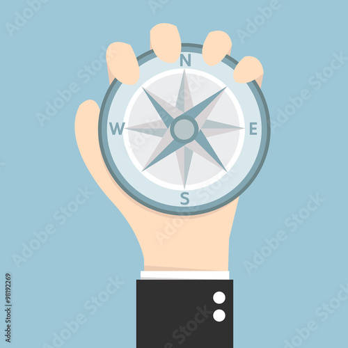 Business man holding compass
