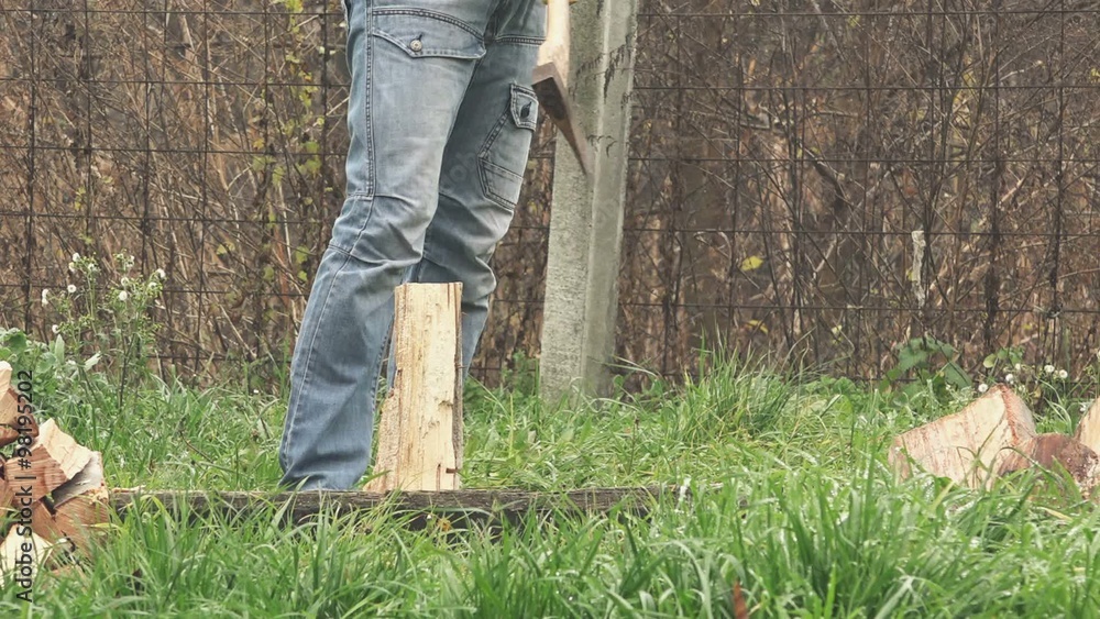 Lumberjack cutting wood logs with axe, man splitting firewood for winter season. Lumberjack cutting wood logs with axe, man splitting firewood for winter season.