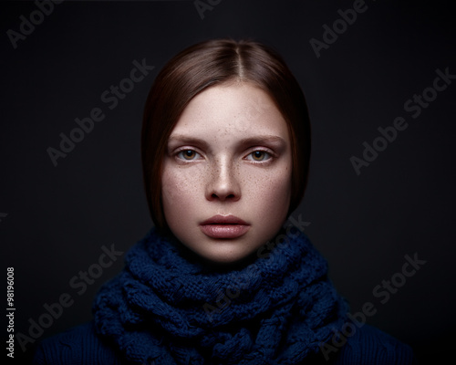 Art portrait of beautiful young girl with freckles