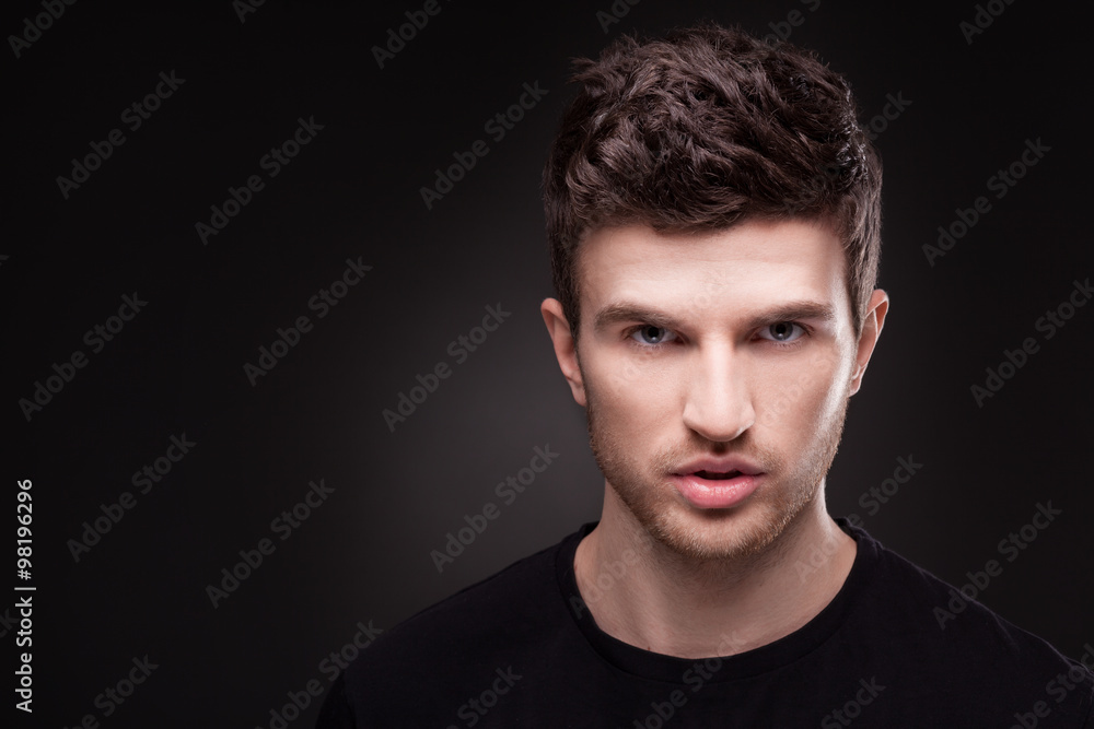 Stylish guy close up portrait on black background Stylish guy close up portrait on black background
