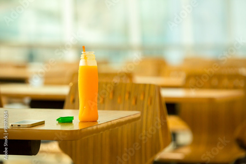 Bottle of orange juice on table.