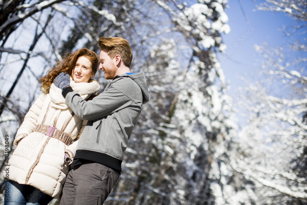 Young couple at winter forest Young couple at winter forest