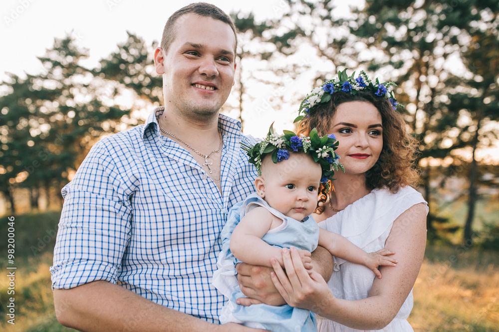 Happy family of mother father and lovely daughter in sunset light. Happy family of mother father and lovely daughter in sunset light.