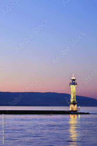 Idyllic illuminated light house at Lake Geneva
