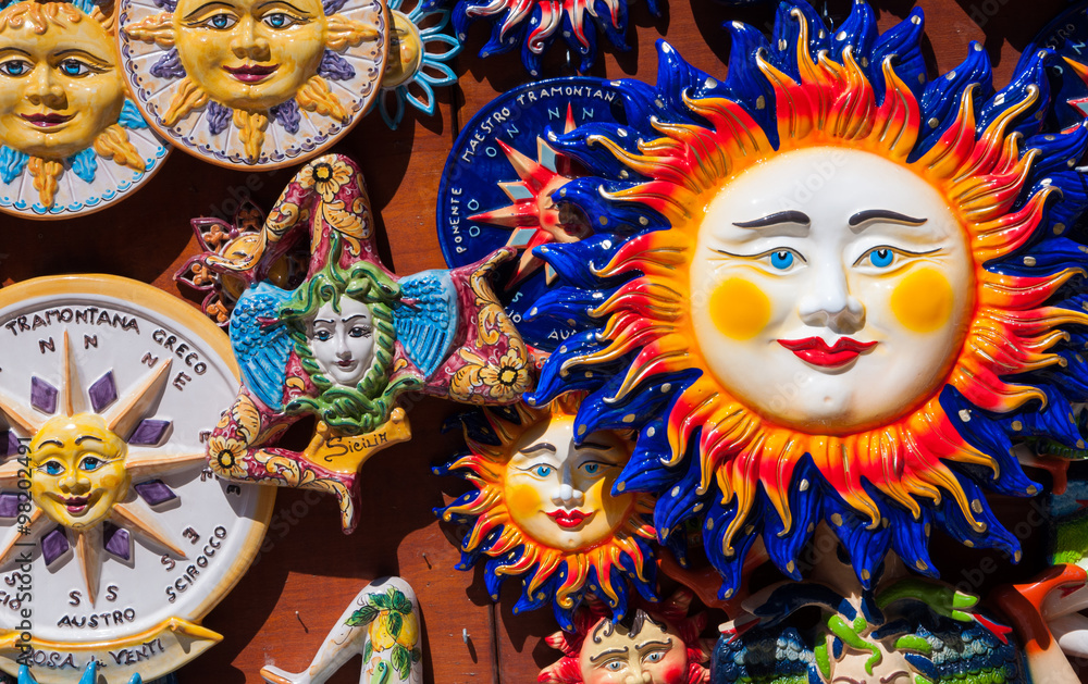 Traditional souvenirs of ceramics and Trinacria is symbol of Sicily, Italy.