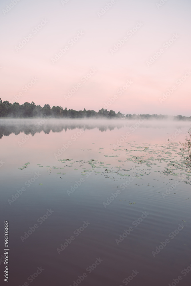 Foggy morning on the country lake - vintage effect
