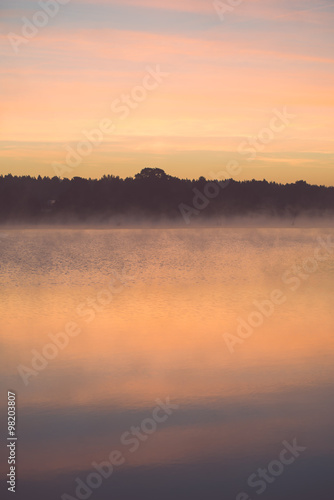 Foggy morning on the country lake - vintage effect