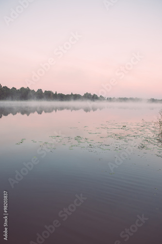 Foggy morning on the country lake - vintage effect