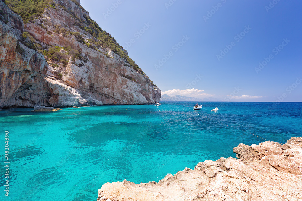 Amazing beach with rocks and blue sky, CALA MARIOLU, BAUNEI, ITALY