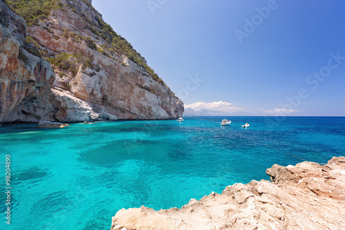 Amazing beach with rocks and blue sky, CALA MARIOLU, BAUNEI, ITALY