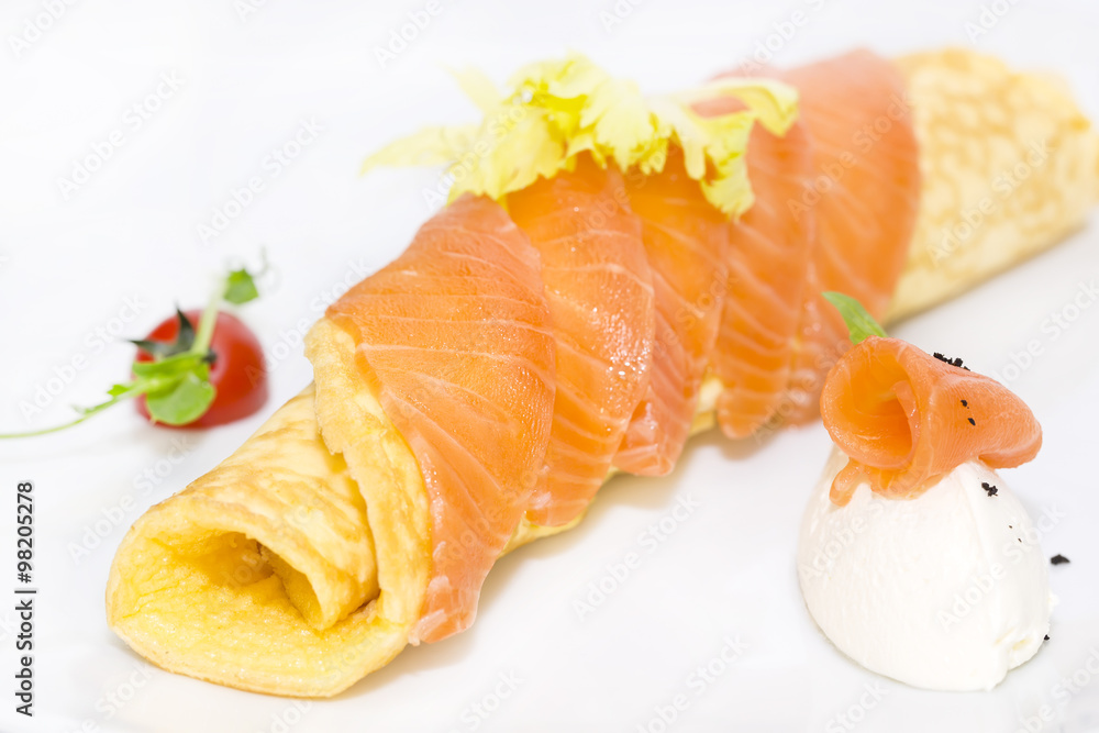 scrambled eggs with cheese and salmon decorated with tomato on white background scrambled eggs with cheese and salmon decorated with tomato on white background