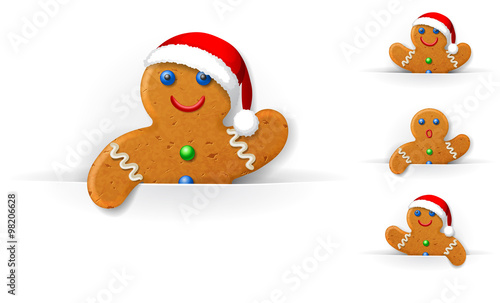 set of Christmas gingerbread mans looks out from a horizontal white paper sheet
