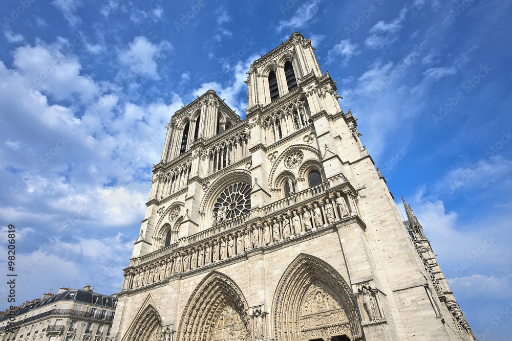 The iconic Notre Dame cathedral in Paris with dramatic clouds