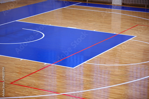 Wooden floor of sports hall with marking lines photo