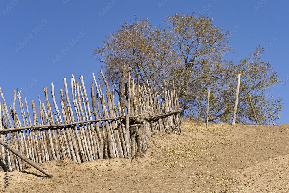 Steep path with wooden fence against blue sky, Inner Mongolia, China Steep path with wooden fence against blue sky, Inner Mongolia, China
