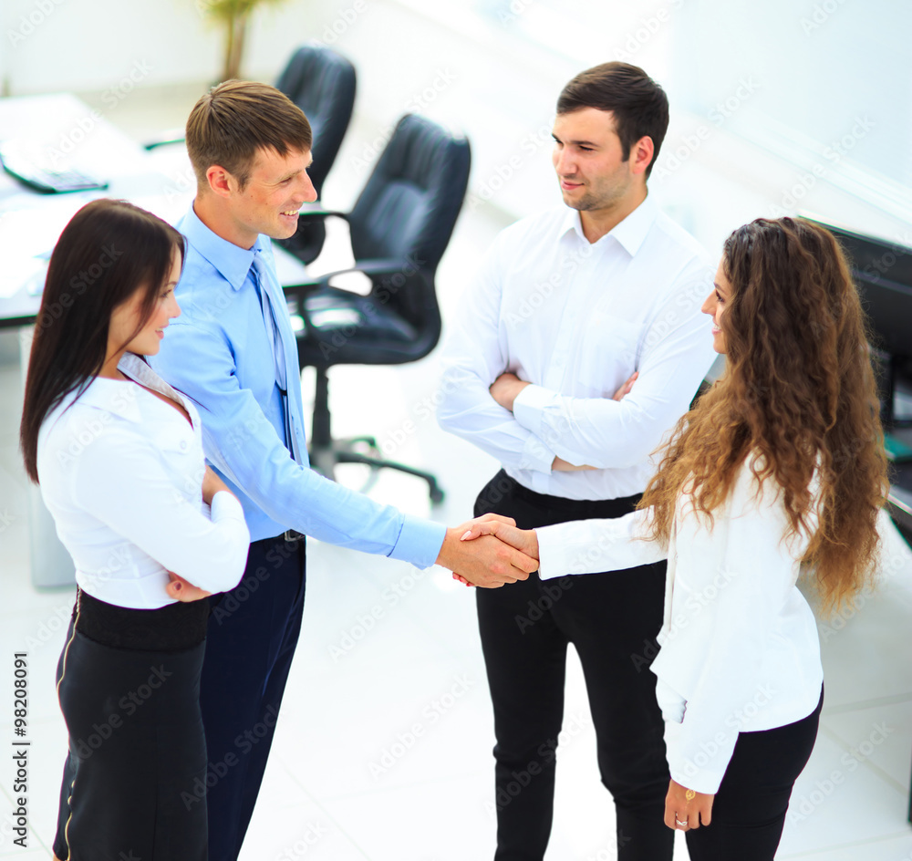 businessman shaking hands to seal a deal with his partner businessman shaking hands to seal a deal with his partner