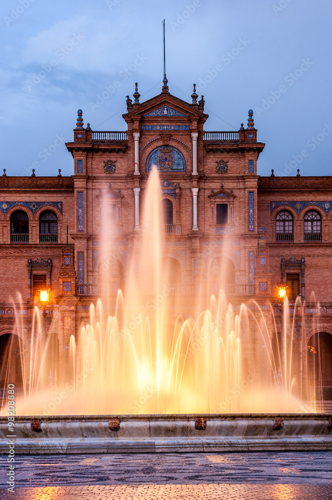 Central source of the popular Spain Square, during a cloudy sunset. The square is in the Andalusia city of Seville