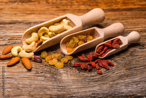 Nuts and other Dried fruits on natural wood photo