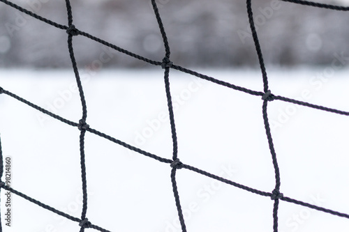 Closeup of Frayed Sports Netting in Winter