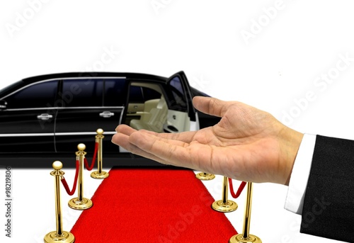 Hand welcome gesture to a luxury limousine ride