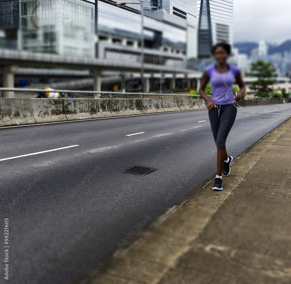 Young woman running outdoors (motion blurred image)