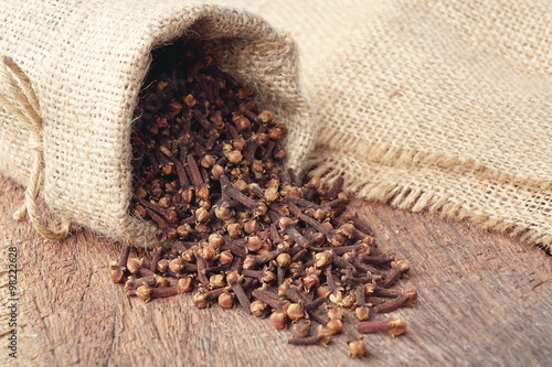 Obraz na plátně Aromatic dried clove flower buds in sackcloth bag