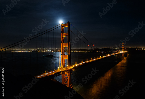 Full moon over the Golden Gate Bridge at night with San Francisco cityscape