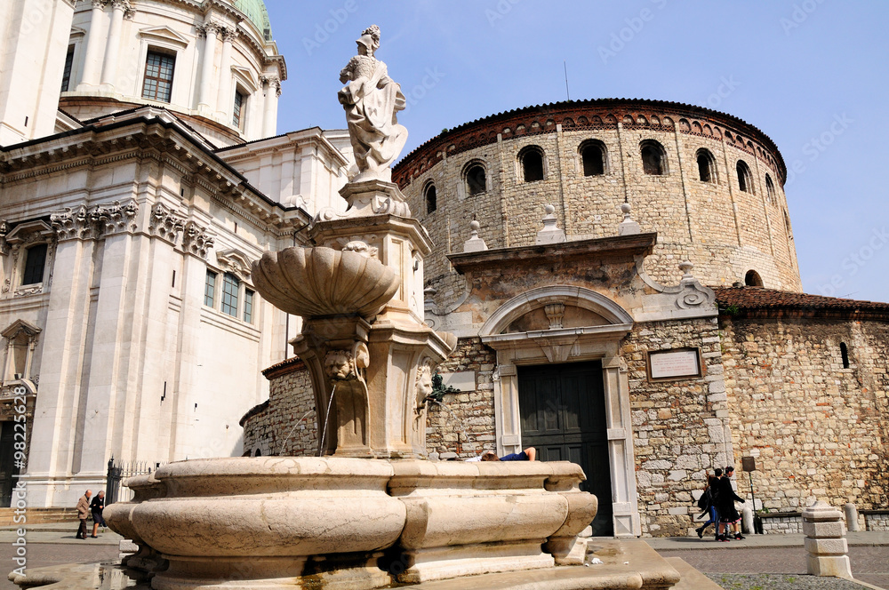 Architectural fountain before new and old Cathedrals of Brescia city. Italy. 