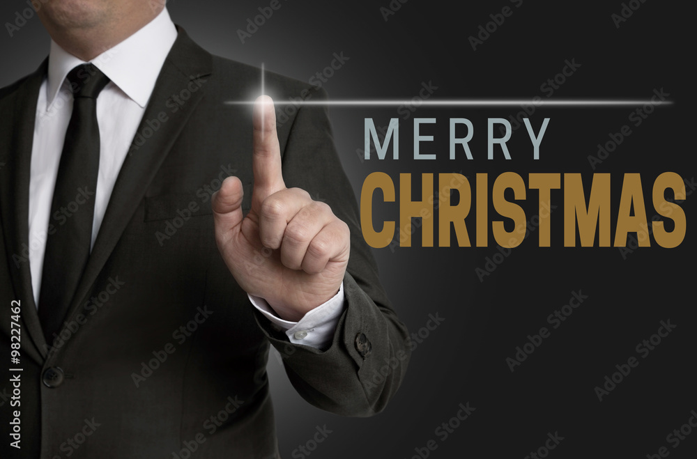 Merry Christmas touchscreen operated by businessman concept Merry Christmas touchscreen operated by businessman concept