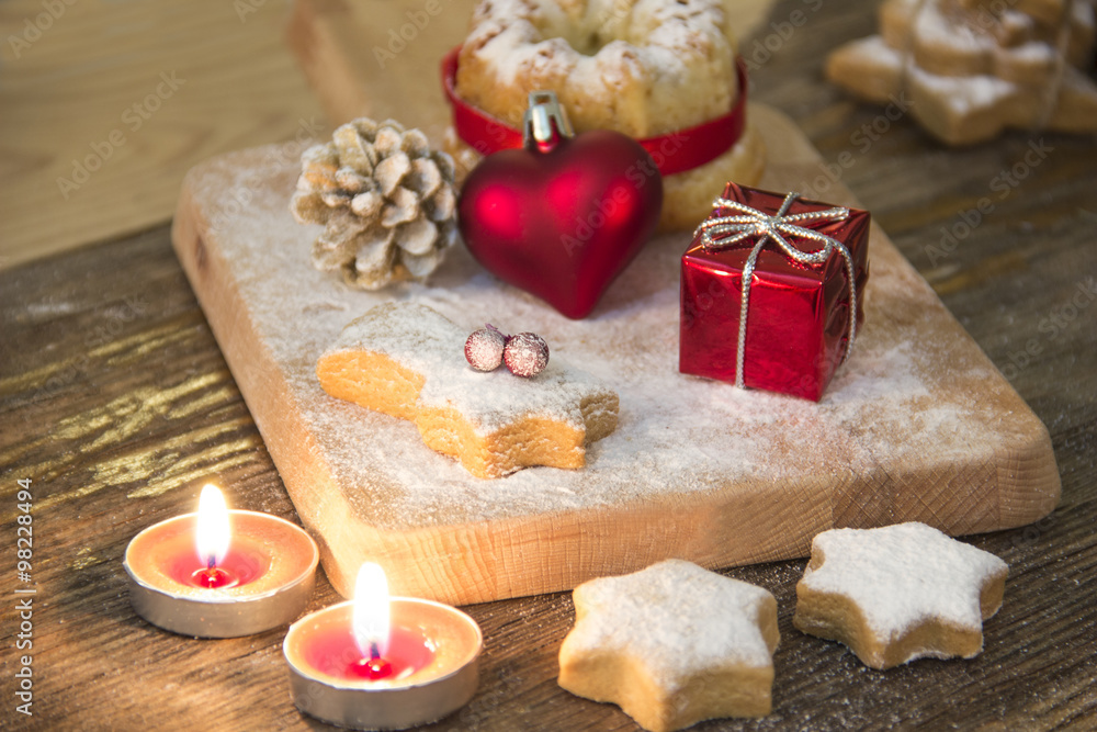 Christmas background with christmas gingerbread cookies and candles on wooden