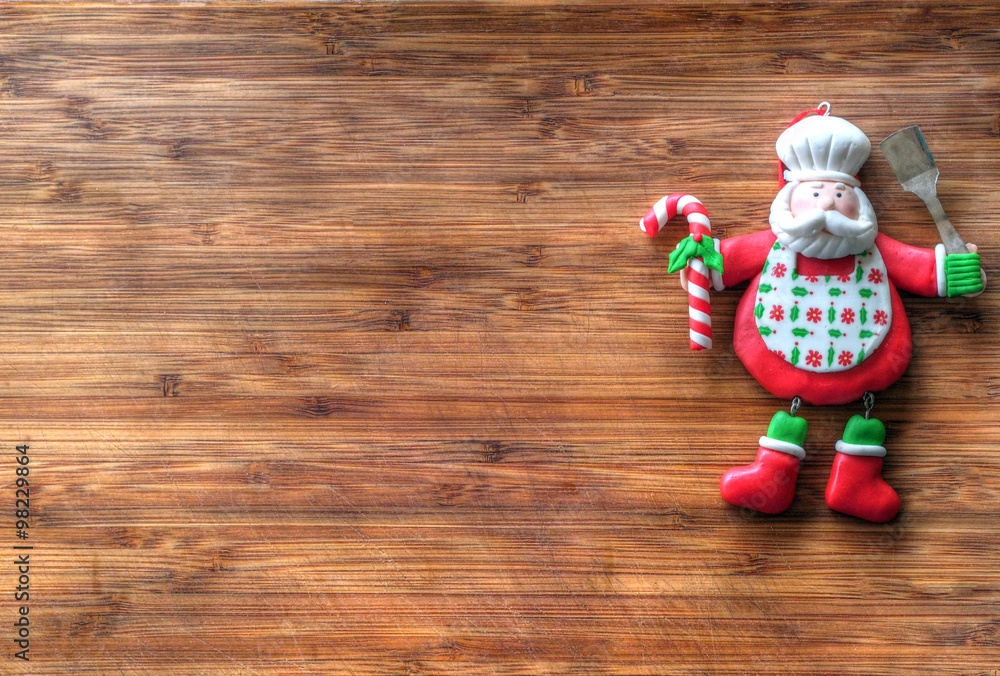 Christmas - old wooden background and funny chef Santa Claus
