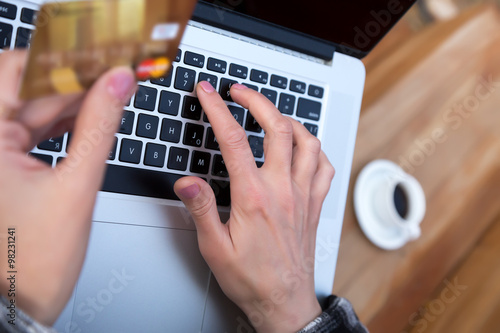 Hands of person entering credit Card Data on Laptop photo