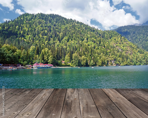 Empty wooden flooring against the lake in mountains