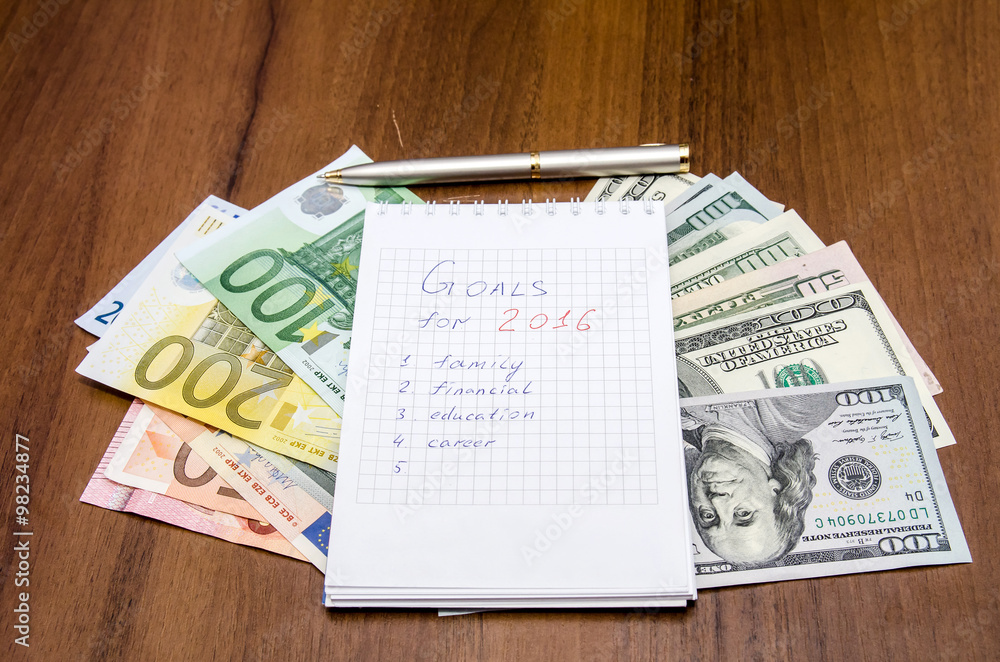 resolutions for new year 2016 with dollar and euro on wooden table resolutions for new year 2016 with dollar and euro on wooden table