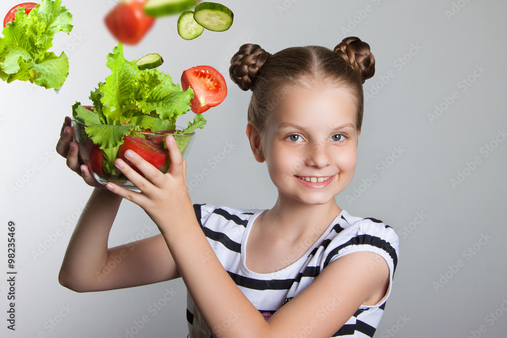 Beautiful smiling girl holding a plate with vegetables Beautiful smiling girl holding a plate with vegetables