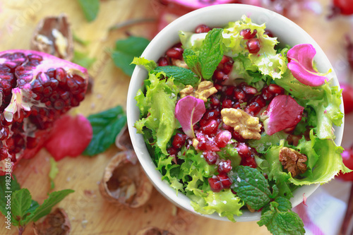 Bilde på lerret Top view of Curly endive salad with pomegranate, nuts...