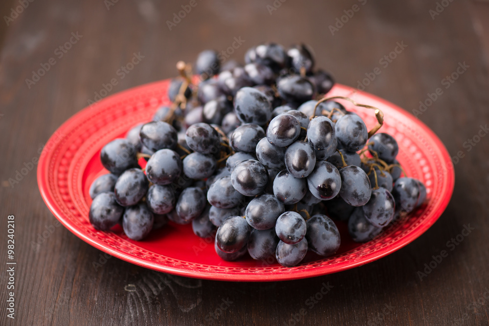 organic red grapes and fir branch with Christmas decorations organic red grapes and fir branch with Christmas decorations